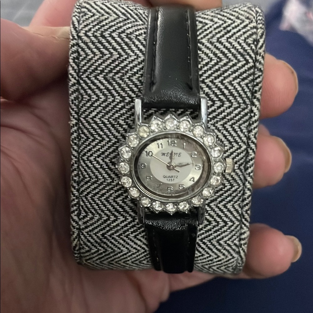 Black and Silver Watch with Round Face and Sparkling Bezel
